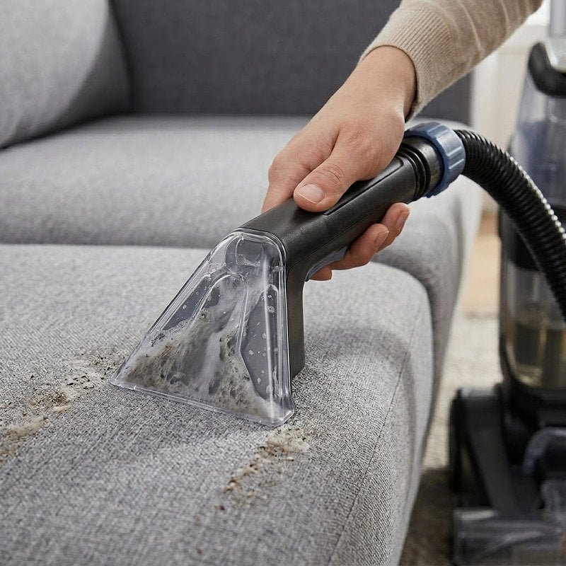 Elegant sofa and upholstered furniture being cleaned with professional equipment