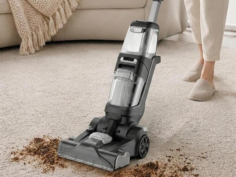 Modern living room with clean carpet and vacuum cleaner removing dirt and debris